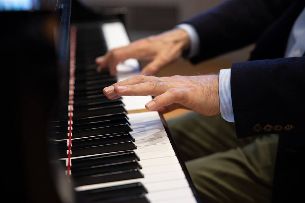 Hands playing a piano