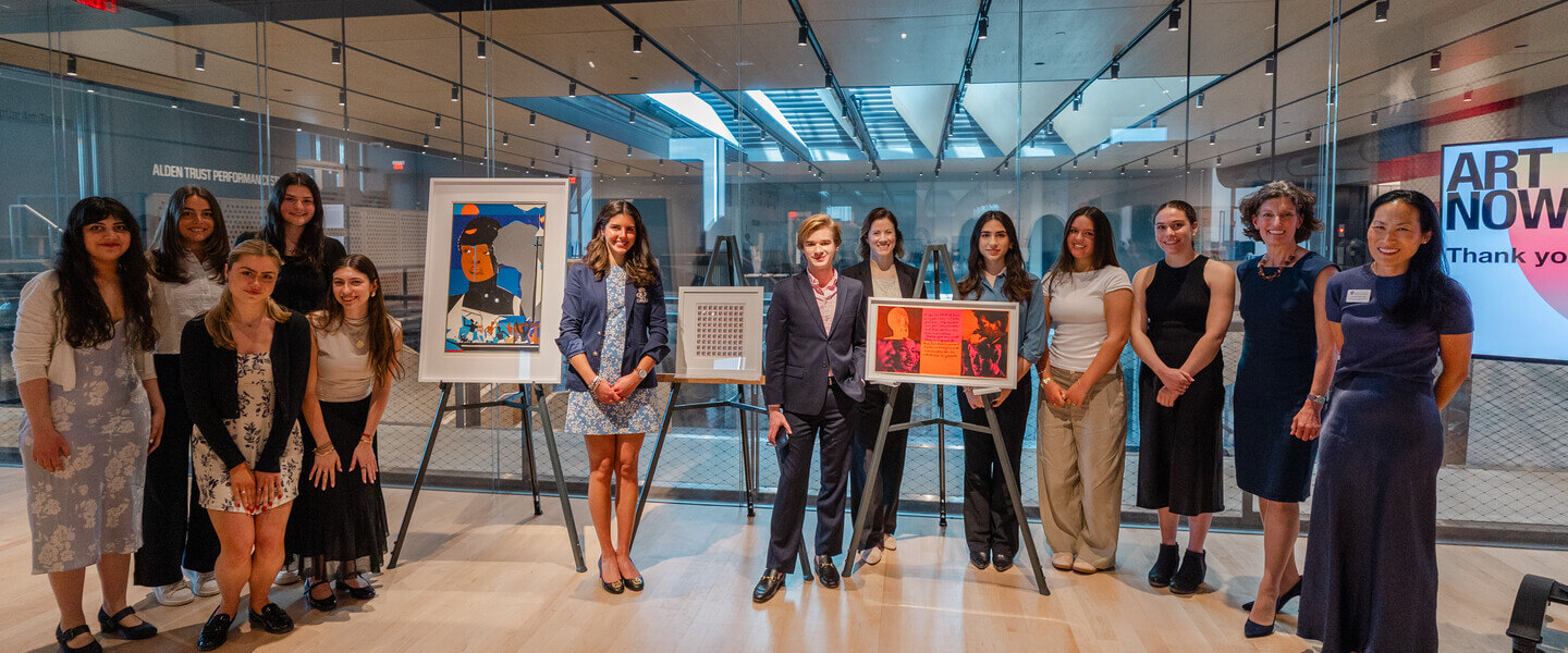 Holy Cross college students stand aside art work