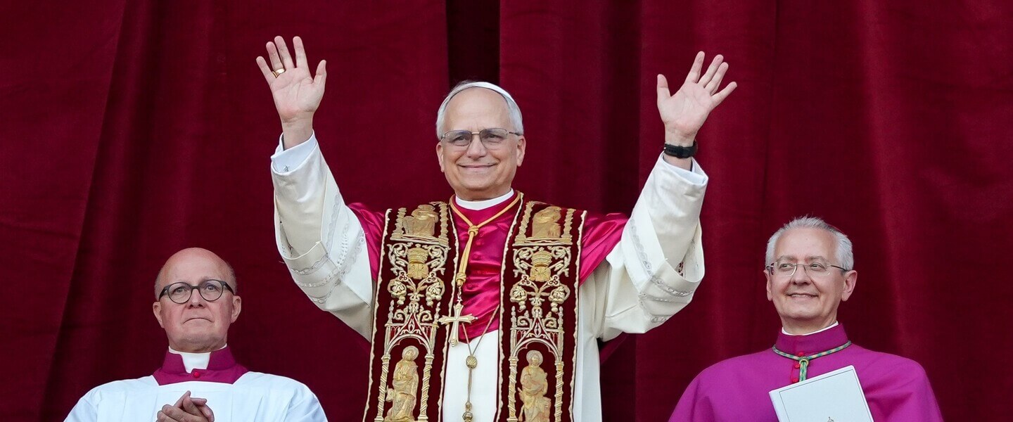 Pope waves at crowd from balcony
