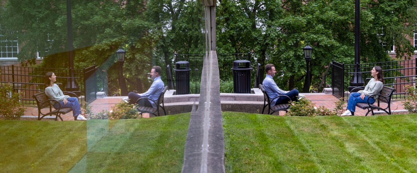 Two people sit across from each other in chairs