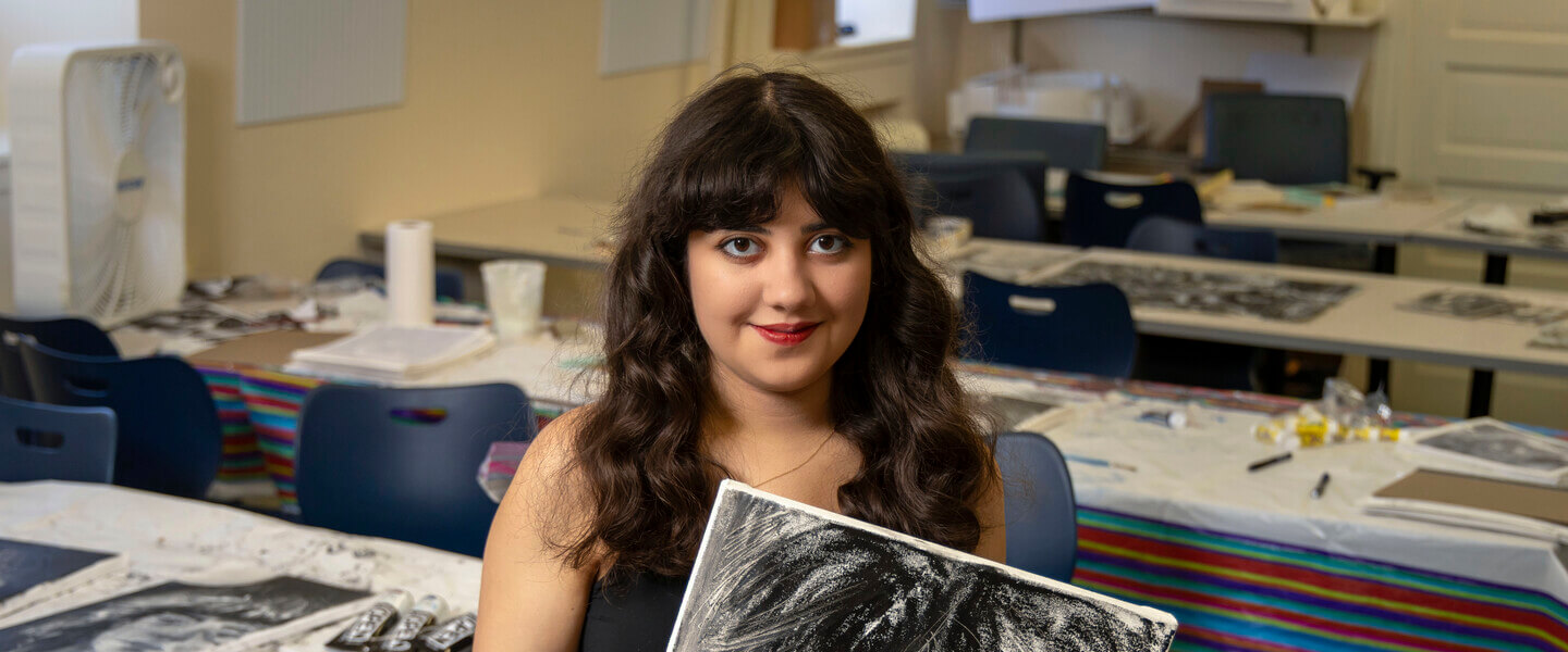 Sophie Sundaram '26 holding a portrait