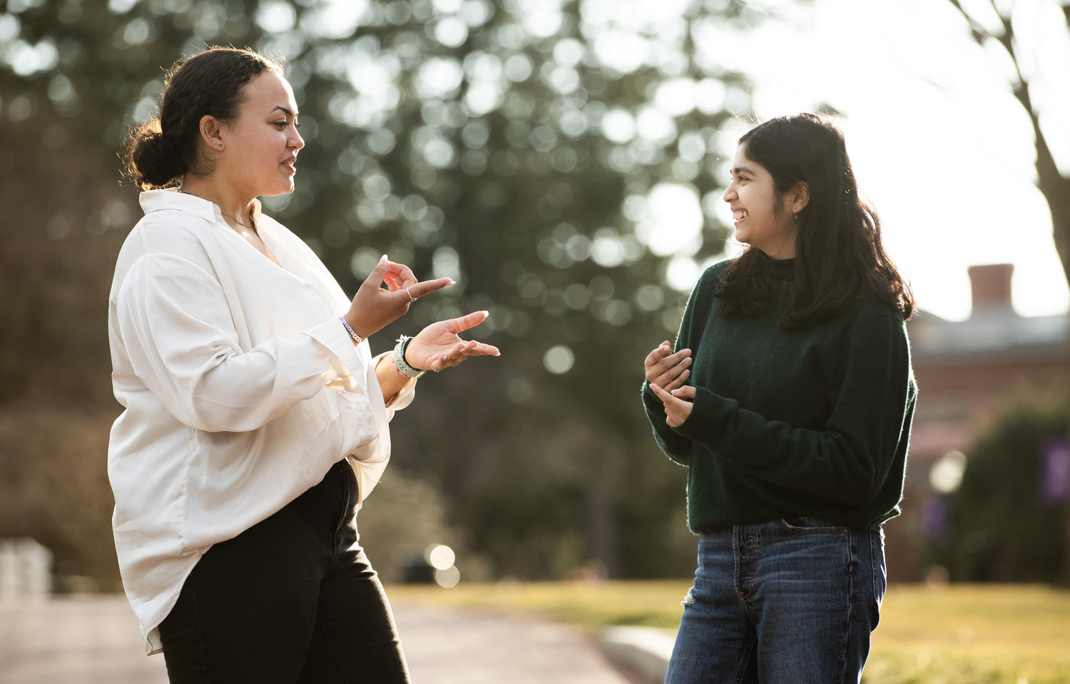 Two women converse using American Sign Language.