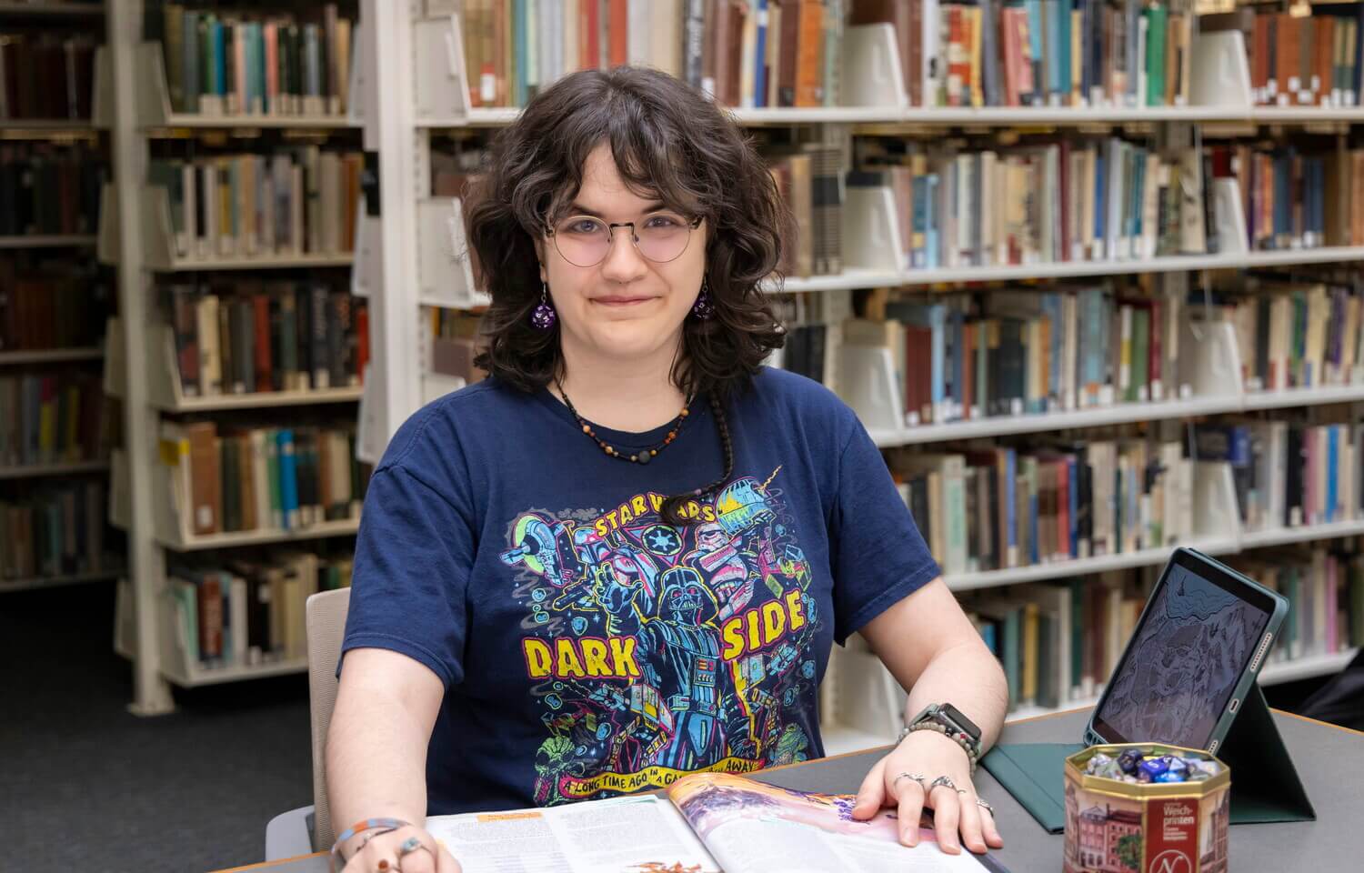 Person sits at table with an open book