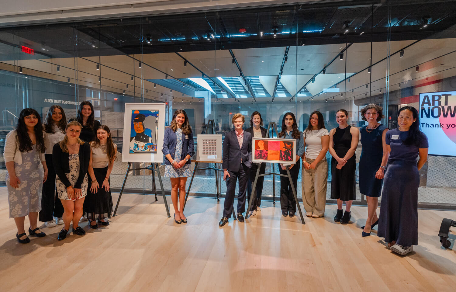 Holy Cross college students stand aside art work