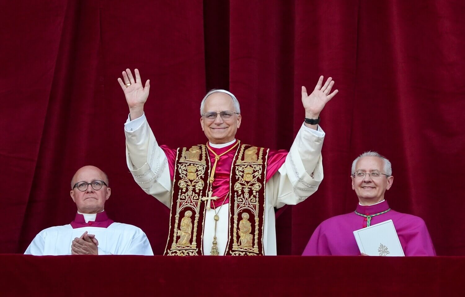 Pope waves at crowd from balcony