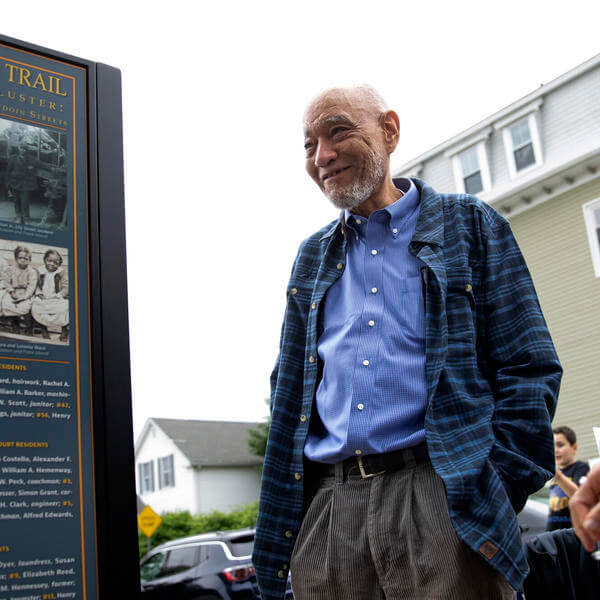 Man stands and looks at sign