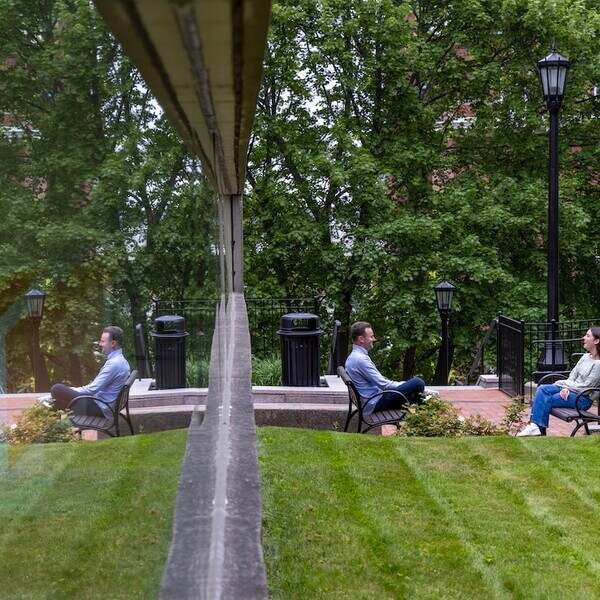 Two people sit across from each other in chairs