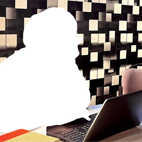 Silhouette of a young woman on her laptop