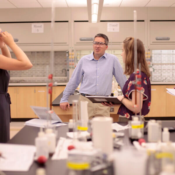 Ken Mills and students in a classroom