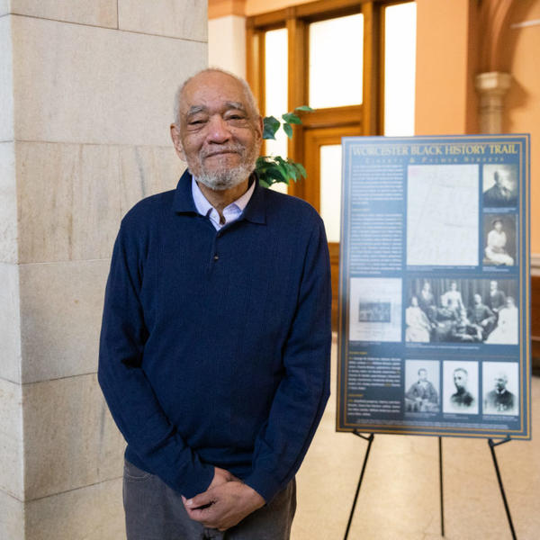 Professor Tom Doughton in front of the City Hall exhibit as part of Worcester's Black History Month celebration.