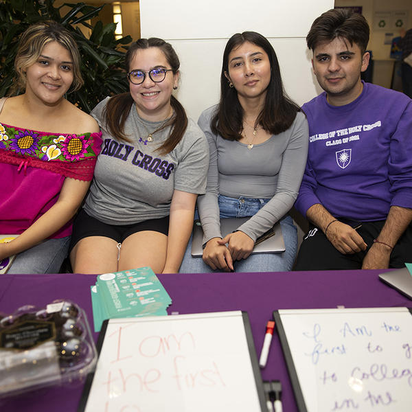 Four students sit at a table