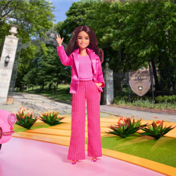 Image of Barbie doll standing in front of brick building at College of the Holy Cross.