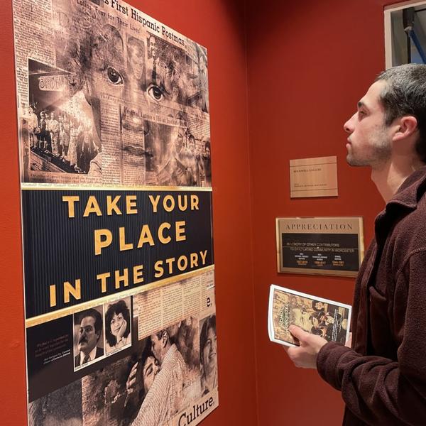 Man looks at exhibit on Latino history in Worcester.