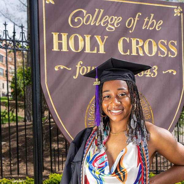 Meah Austin Class of 2022 standing in front of College of the Holy Cross sign.