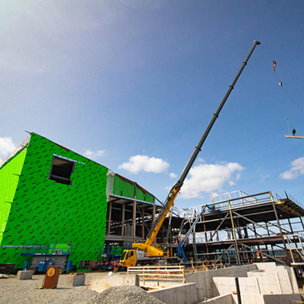 A beam is lifted into place at the Prior Center for Performing Arts