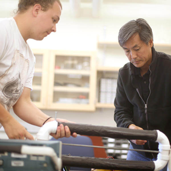 Samuel Habein '17 and Professor and Department Chair Tomohiko Narita build a cosmic ray telescope during Summer Research 2015.