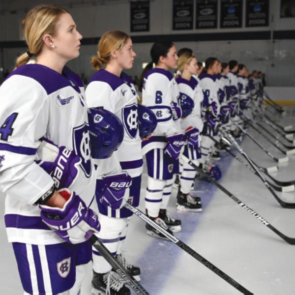Members of the Women's Ice Hockey Team stand on the ice prior to starting a game
