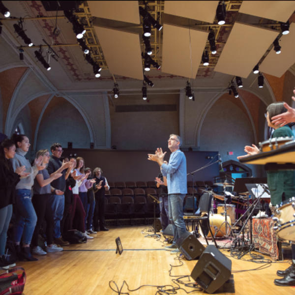 Jonathan Mulrooney speaks in front of a classroom full of students