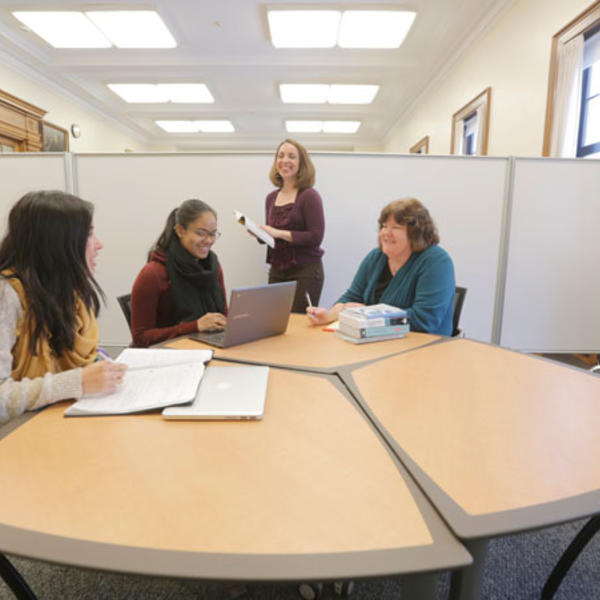 Center for Writing Director Laurie Ann Britt-Smith, far right, and Associate Director Kristina Reardon, standing, work with students on their writing