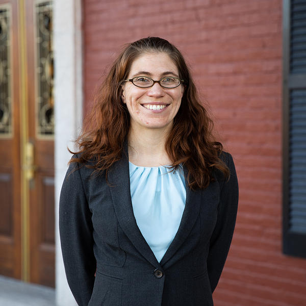 Rebecca Winarski stands in front of a door on Fenwick porch