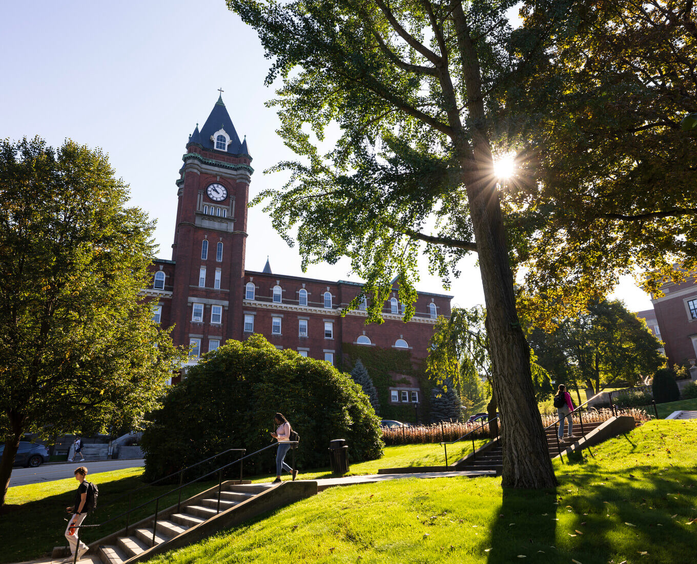 Students walk down stairs with O'Kane tower in background