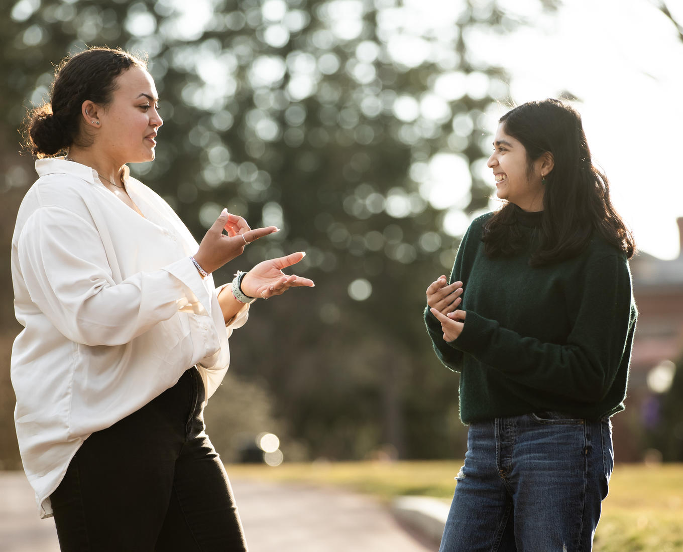 Two women converse using American Sign Language.