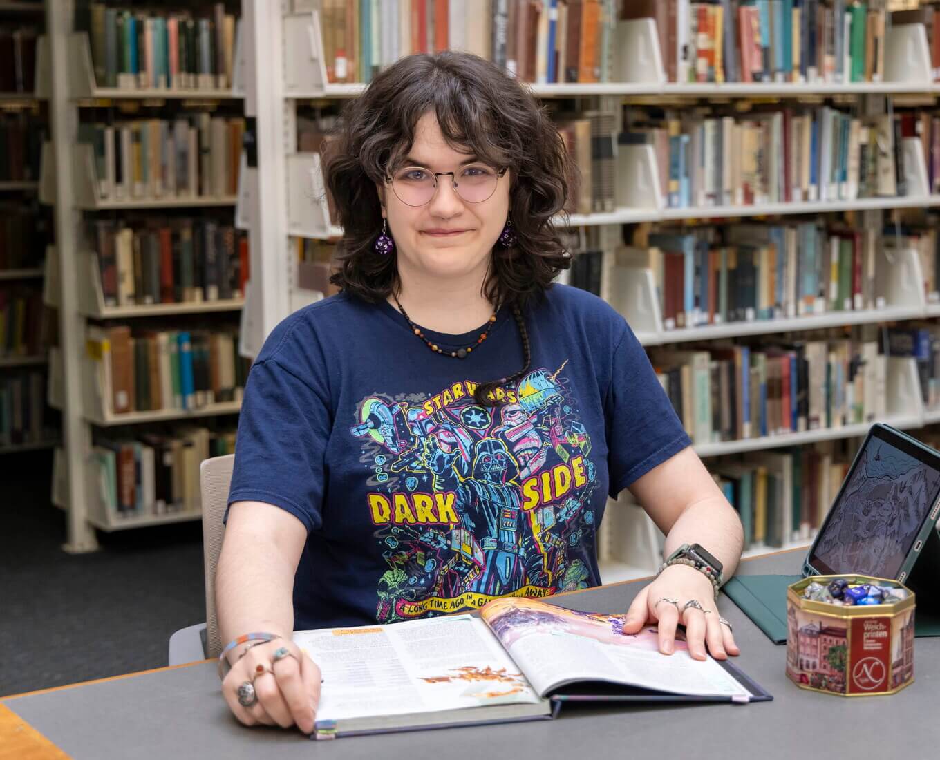 Person sits at table with an open book