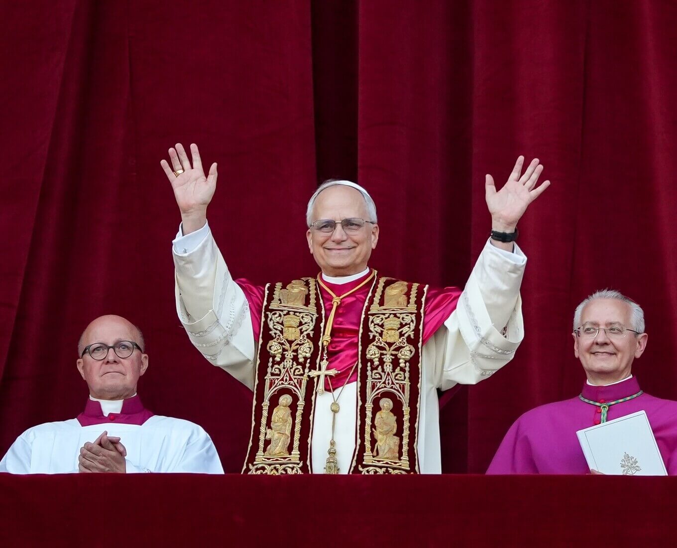 Pope waves at crowd from balcony