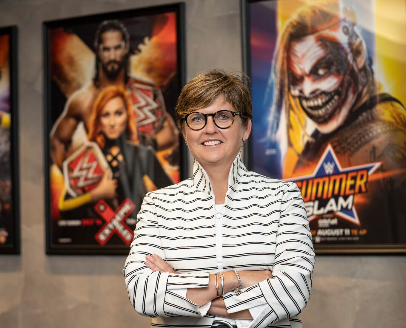 woman stands in front of three posters