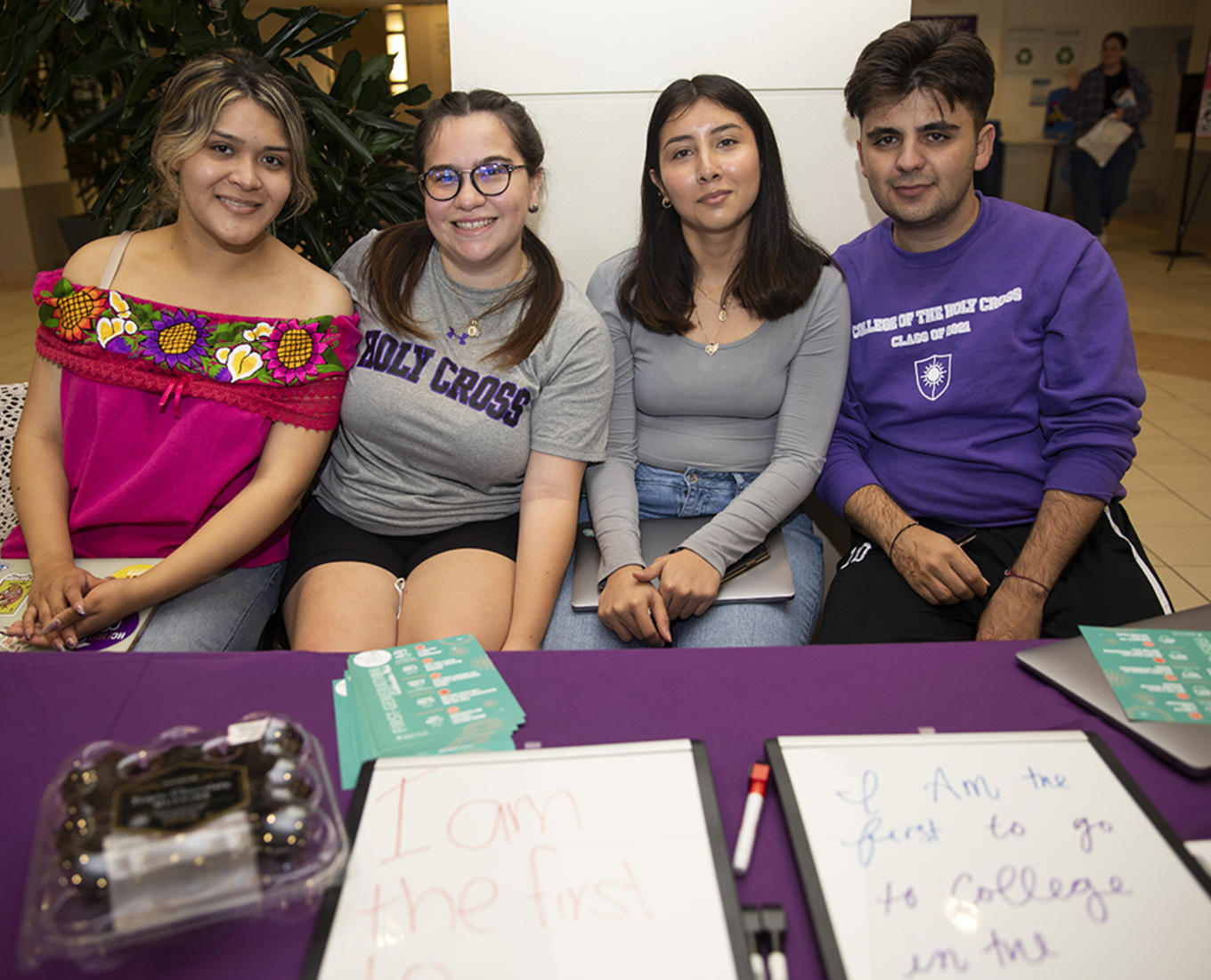 Four students sit at a table