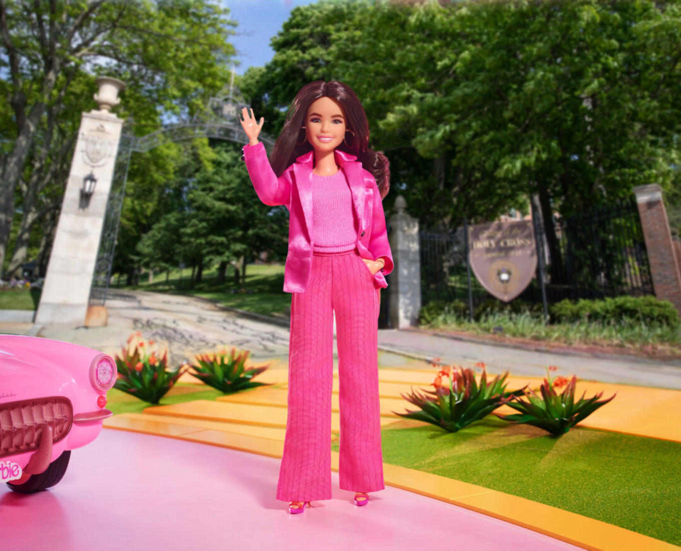 Image of Barbie doll standing in front of brick building at College of the Holy Cross.