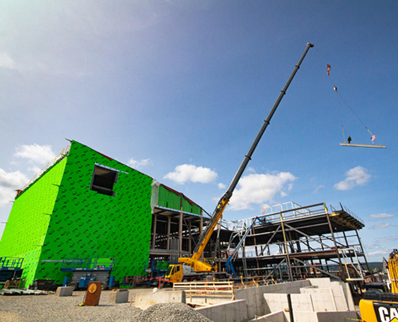 A beam is lifted into place at the Prior Center for Performing Arts
