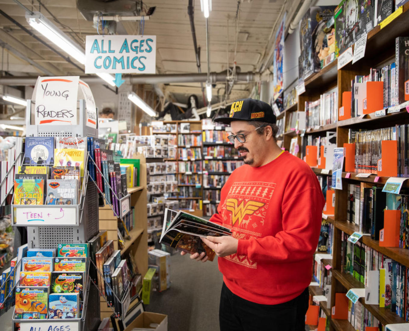 Jorge Santos, associate professor of English, browsing through the comic books at That's Entertainment in Worcester. Photo by Avanell Chang