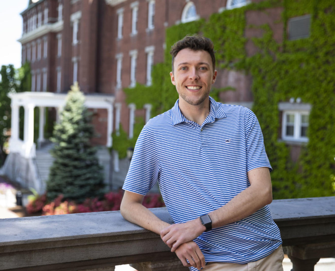 Sean Sova poses in front of a balcony at the College of the Holy Cross.