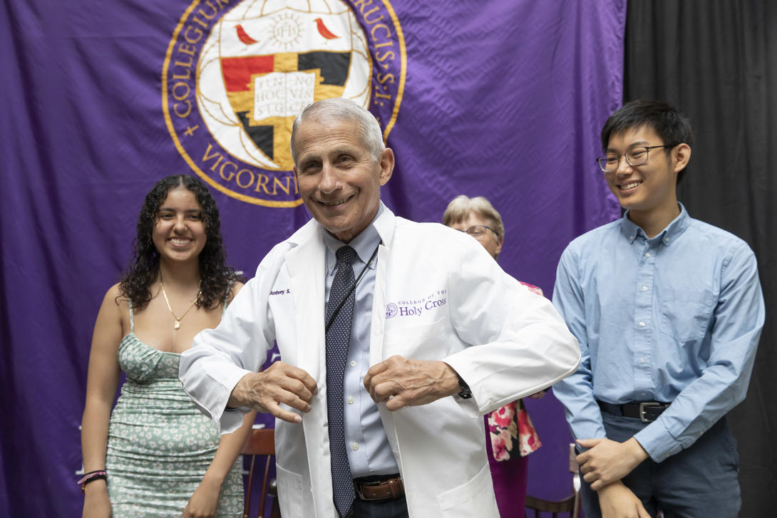 Dr. Anthony Fauci wearing a white doctor's coat smiling