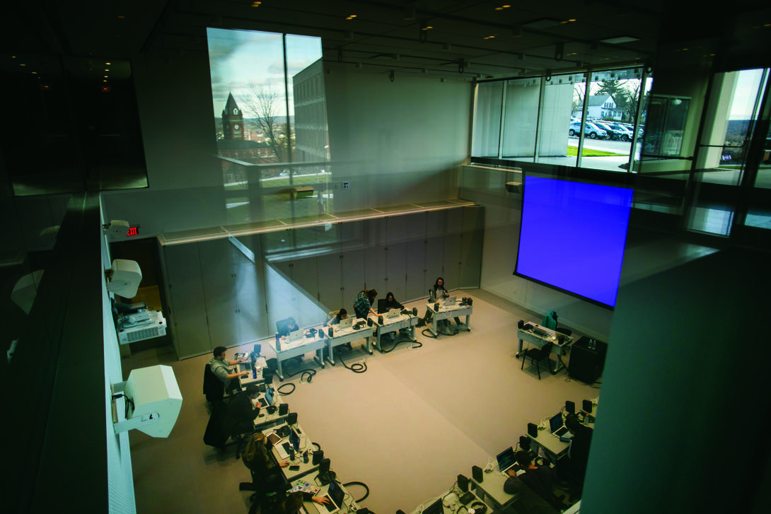 An aerial view of students working on computers in a large circle.