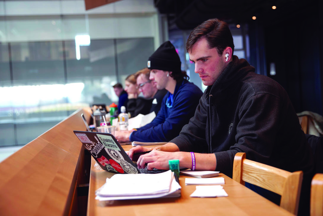 Students studying at long table.