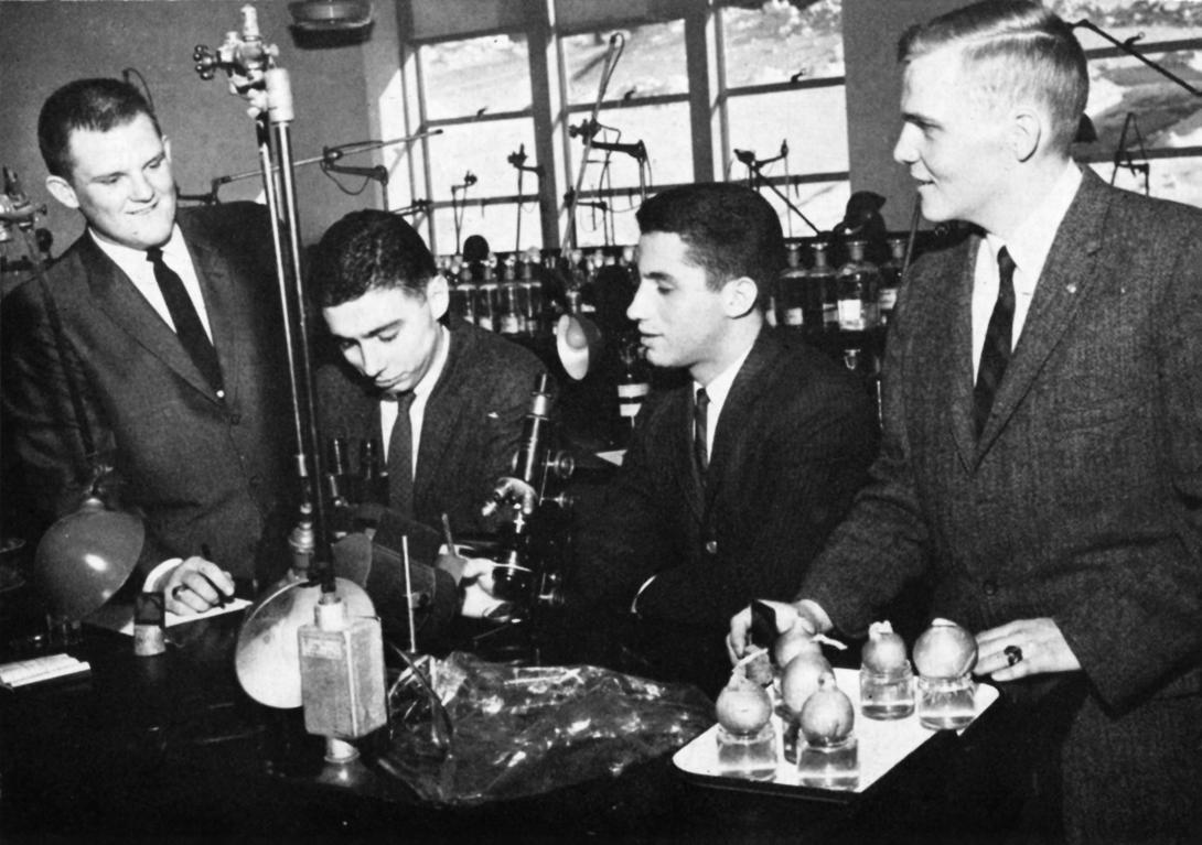 Archival photo of Anthony Fauci and other students with lab equipment.