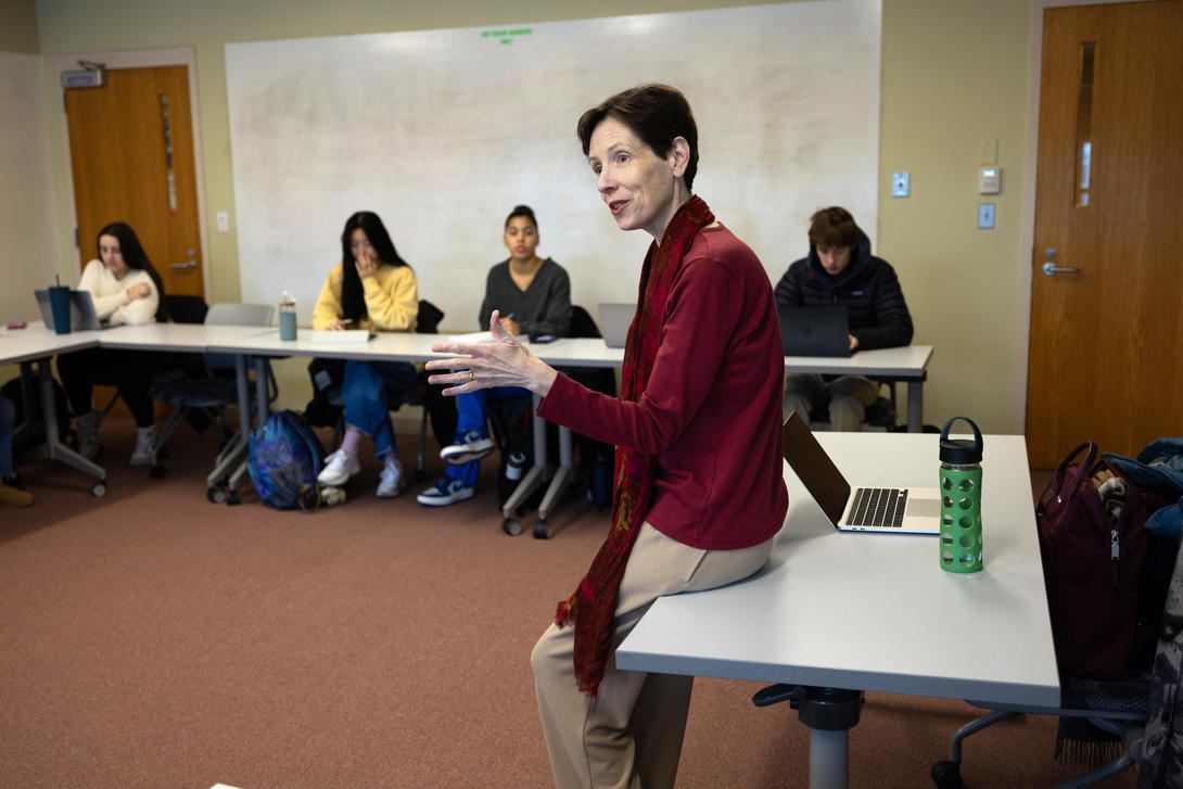 Female professor of religious studies leads a class discussion. 